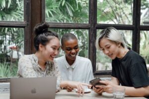 Three women talking and laughing